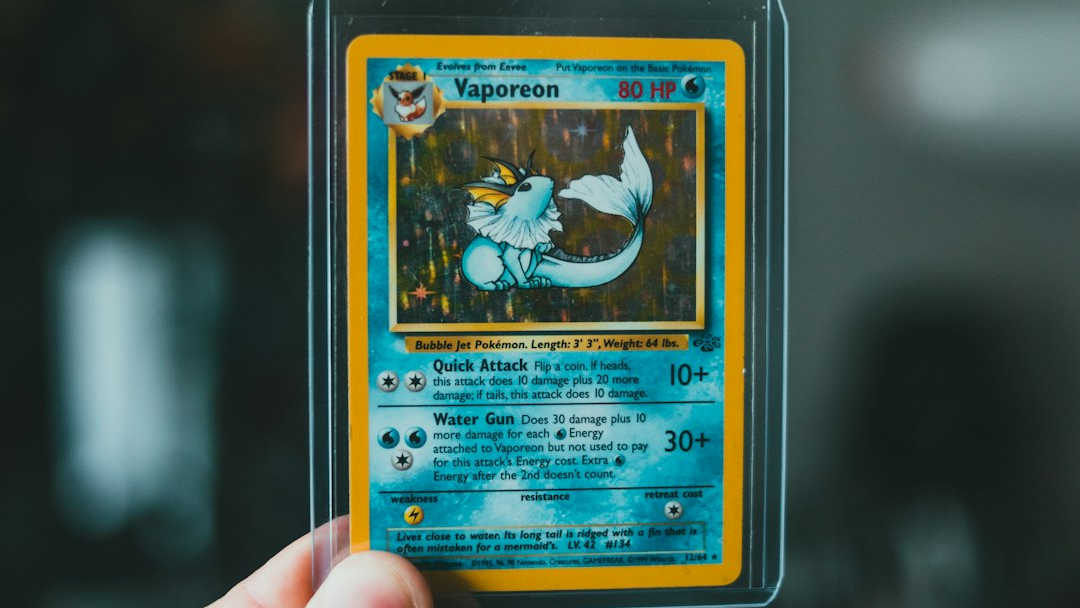 Photograph of an English Vaporeon card in a transparent rigid holder being held for viewing; an illustration of a physical copy, not an identified error or current stock.
