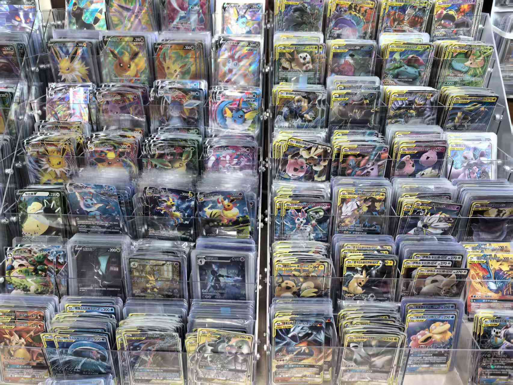 Real Simplified Chinese Pokémon cards arranged in sorting trays